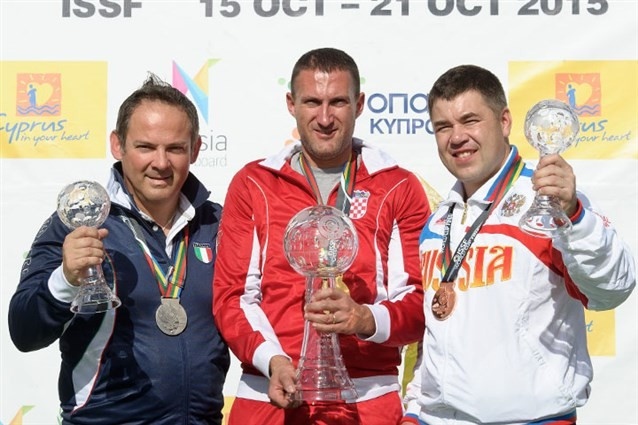 Giovanni Cernogoraz (centre) celebrates following his gold medal in the trap event ©ISSF