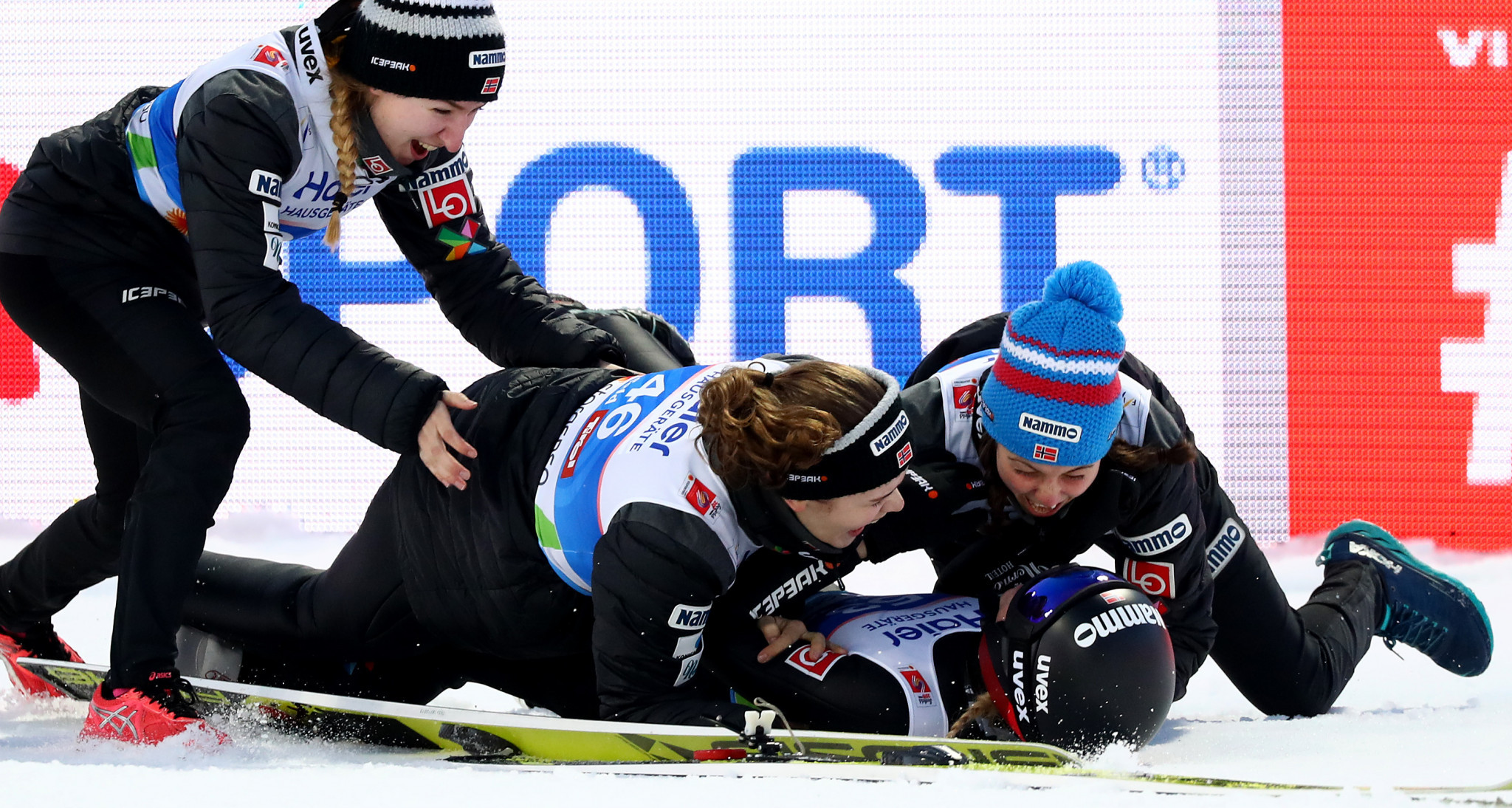 Back on the snow Norway's Maren Lundby was swamped by her teammates after winning the women's ski jumping final ©Getty Images