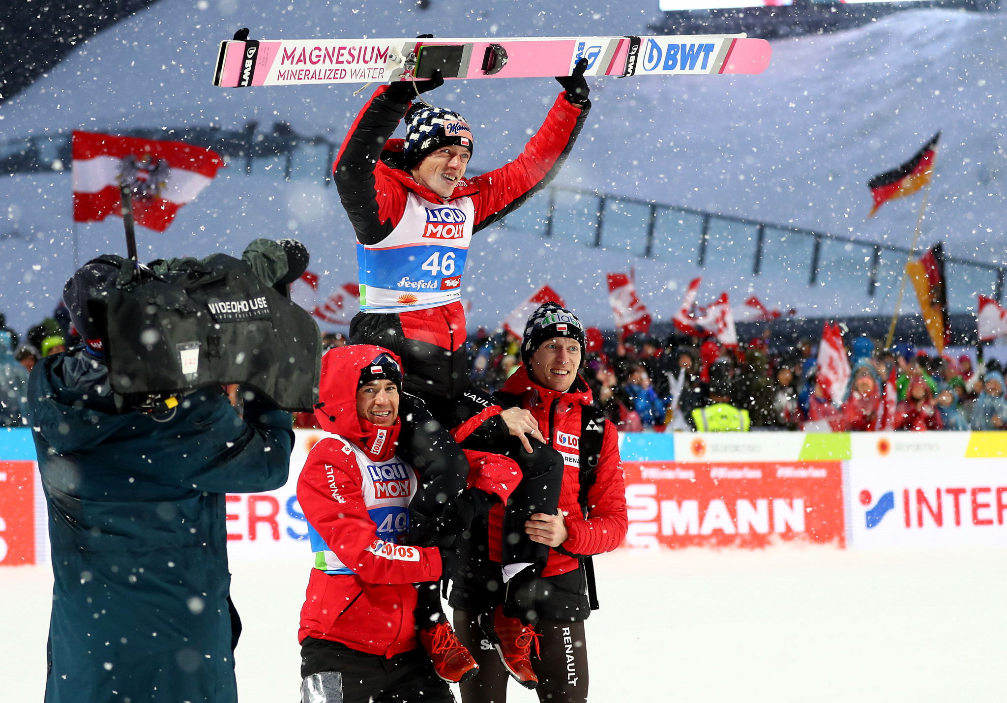 Dawid Kubacki was greeted by his jubilant team-mates following his shock victory ©Getty Images