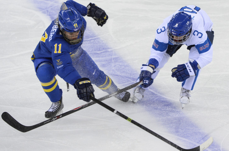 Emma Terho, right, challenges Sweden's Cecilia Ostberg in the quarter-final of the Sochi 2014 tournament – her fifth in Finnish colours ©Getty Images