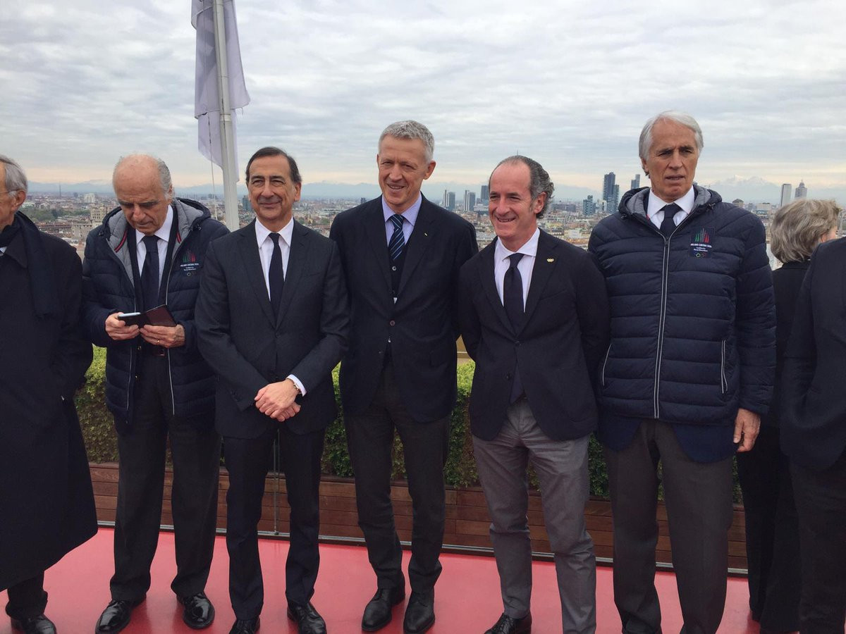 IOC Evaluation Commission chair Octavian Morariu stands alongside the group from Milan Cortina 2026 ©Milan Cortina 2026