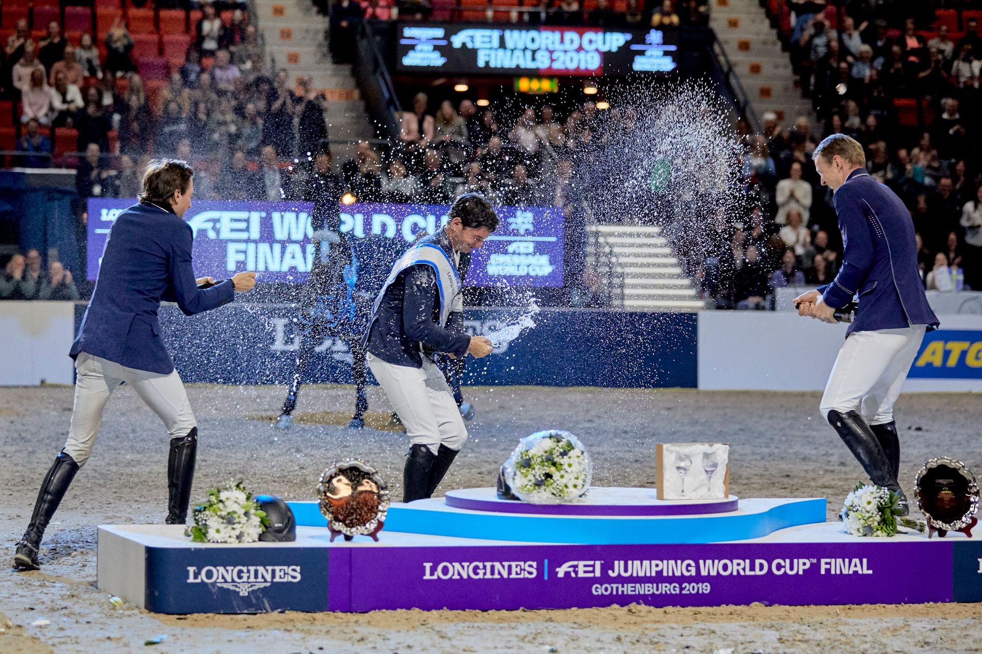 Switzerland's Steve Guerdat, centre, celebrates his third FEI World Jumping Cup Final victory in Gothenburg with his fellow medallists ©FEI