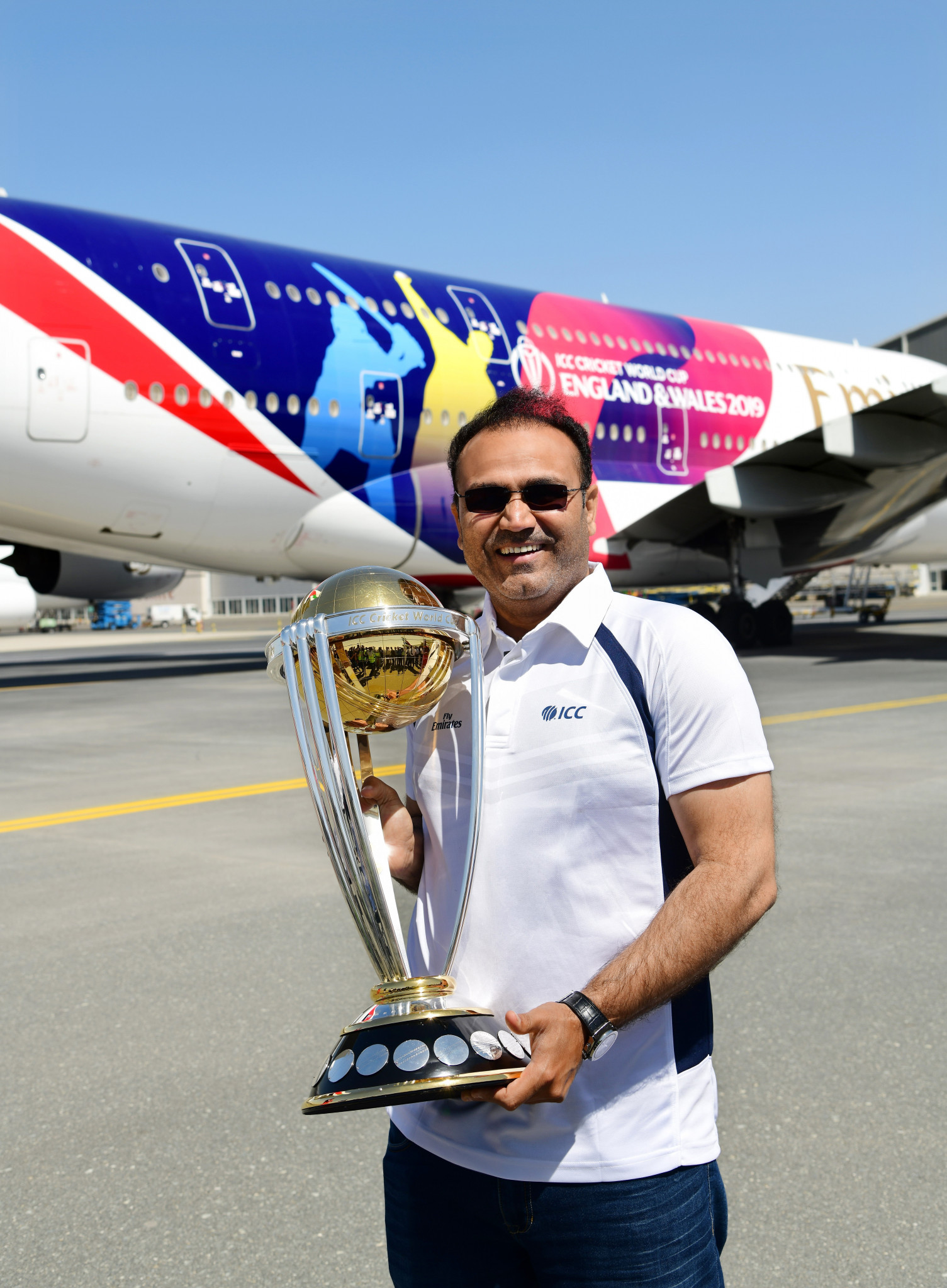 Former India cricketer Virender Sehwag showed off the Men's Cricket World Cup trophy ©ICC
