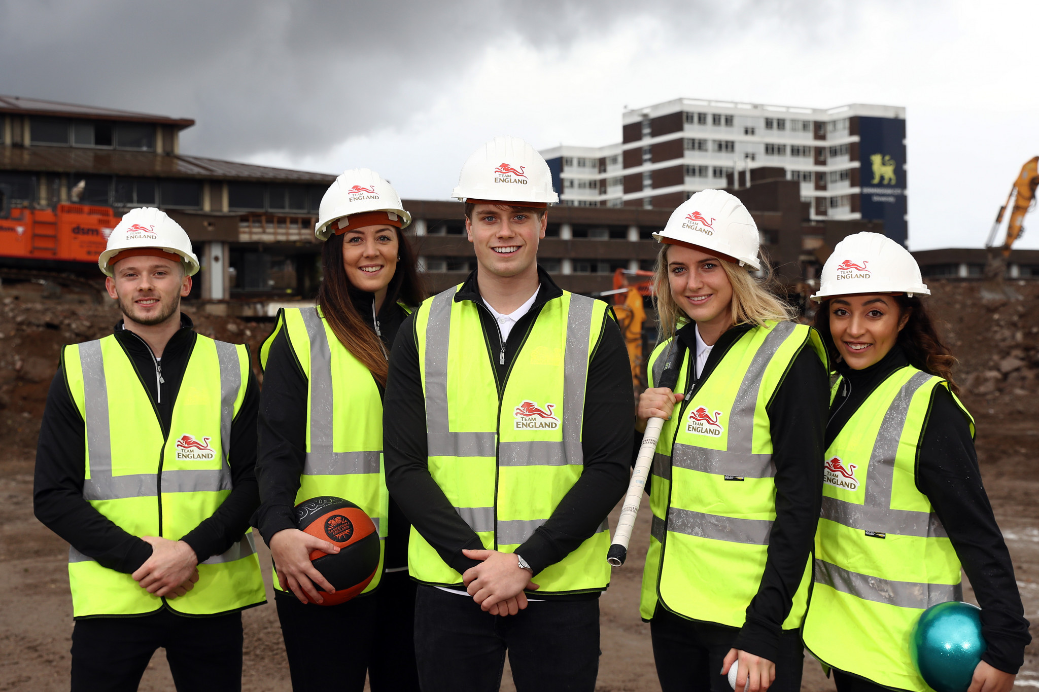 Team England athletes Dominick Cunningham (gymnast), Siobhan Prior (basketball) Tom Hamer (swimmer), Lily Owsley (hockey) and Mimi Cesar (gymnast) at the proposed site for the 2022 Commonwealth Games Athletes' Village ©Getty Images