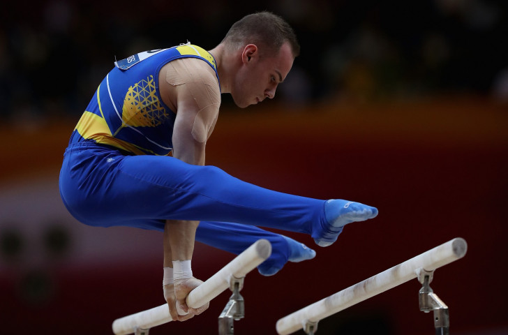 Oleg Verniaiev, Ukraine's Rio 2016 parallel bars champion, applauded the routine put together by China's 21-year-old Zou Jingyuan as he won the world title in Doha last year ©Getty Images