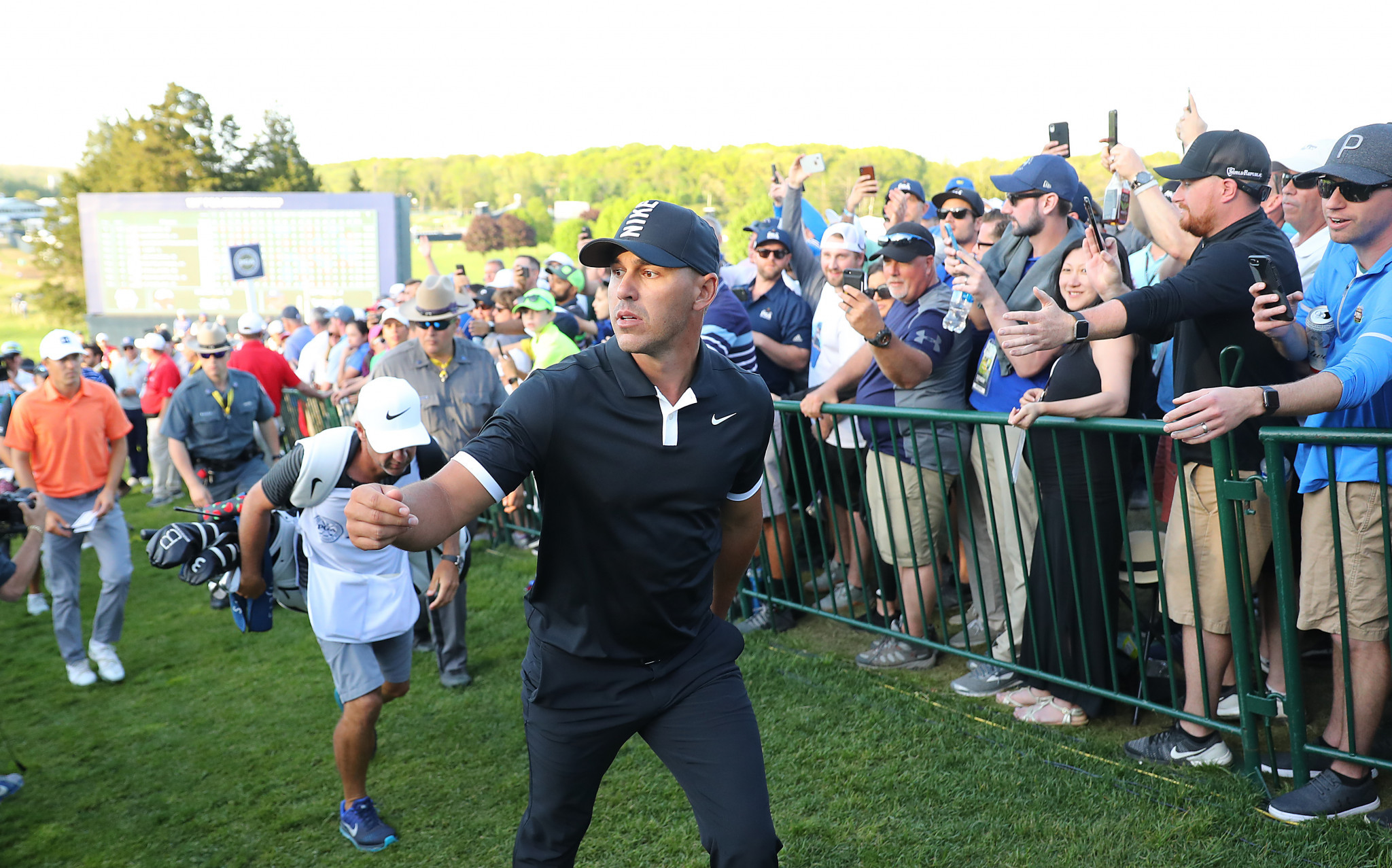 Brooks Koepka leaves the 18th green after maintaining his huge advantage ©Getty Images