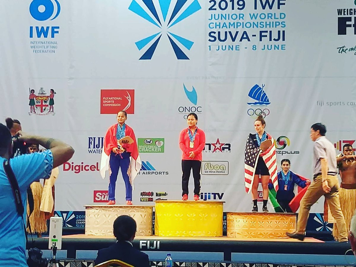 China's Jinhong Zhao, centre, returned from a three-year international absence to win the gold medal in the 49kg category at the IWF Junior World Championships ©Twitter