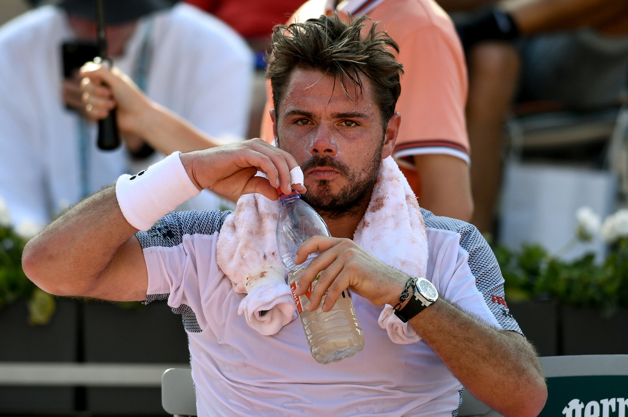 An exhausted Wawrinka takes a drink during his five-hour marathon match with Tsitsipas ©Getty Images