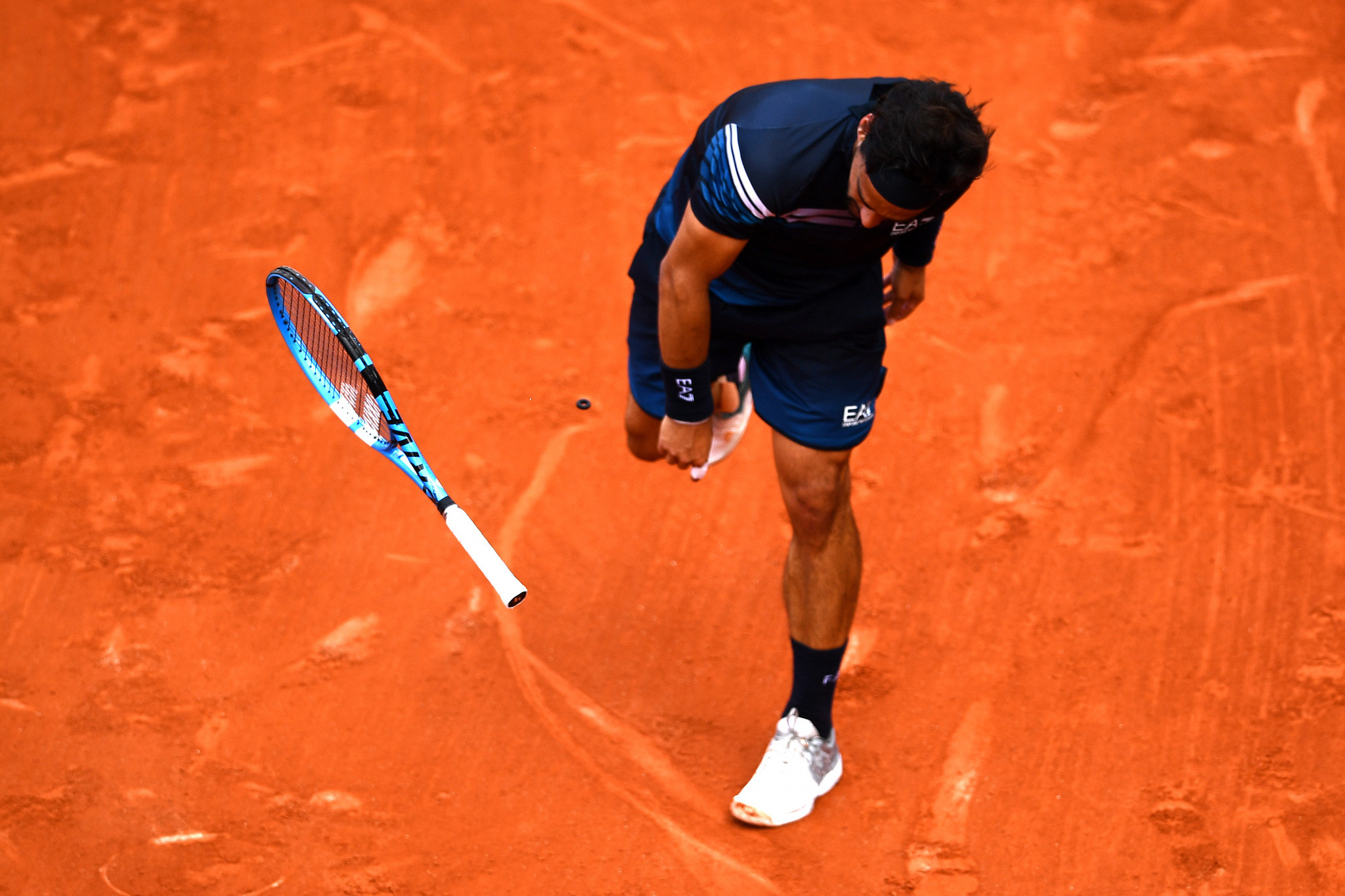Fabio Fognini throws his racket to the clay in frustration on his way to defeat against the number five seed ©Getty Images