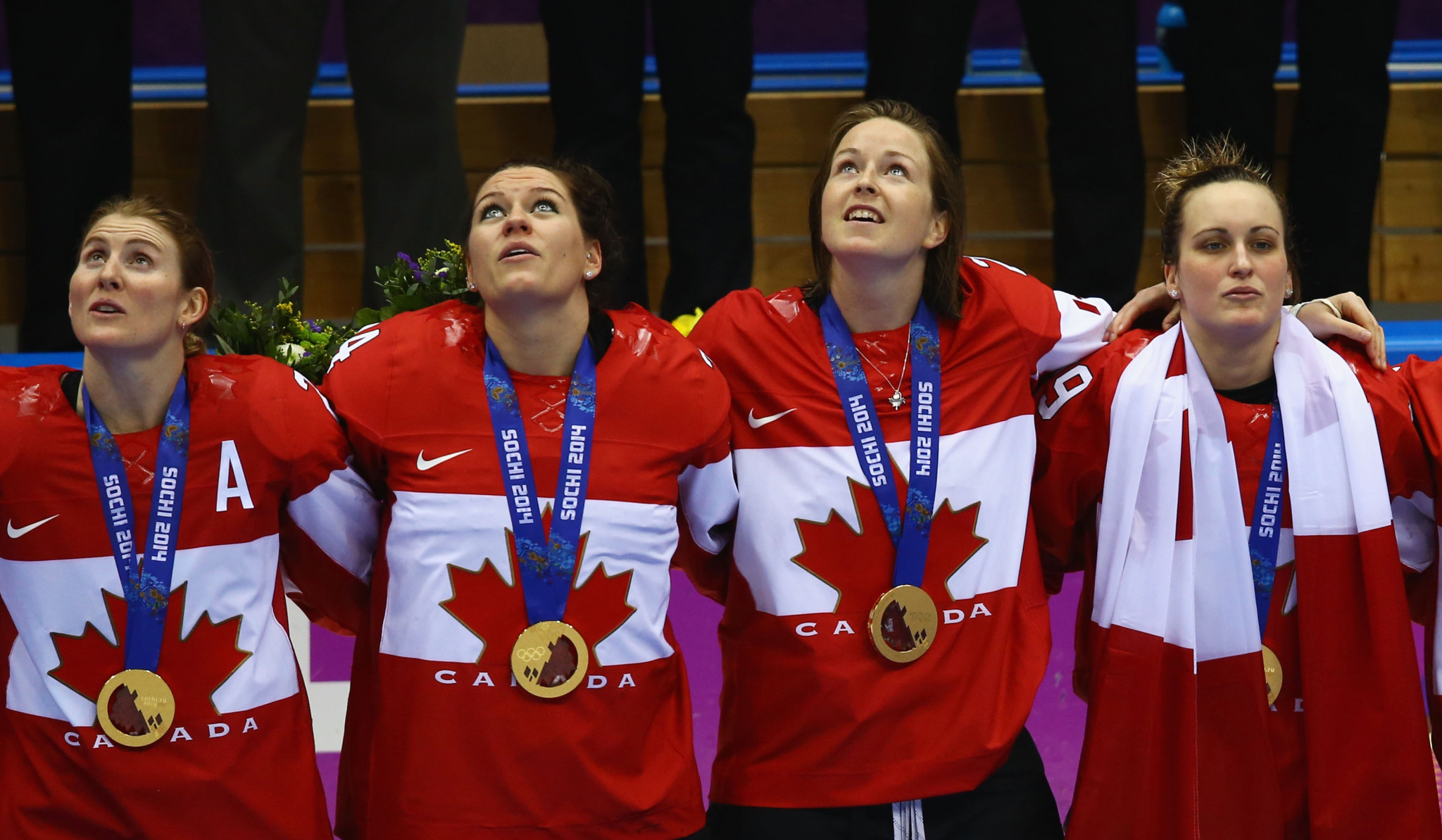 Canada's Hayley Wickenheiser, left, celebrates winning her fourth consecutive Olympic gold medal at Sochi 2014 ©Getty Images