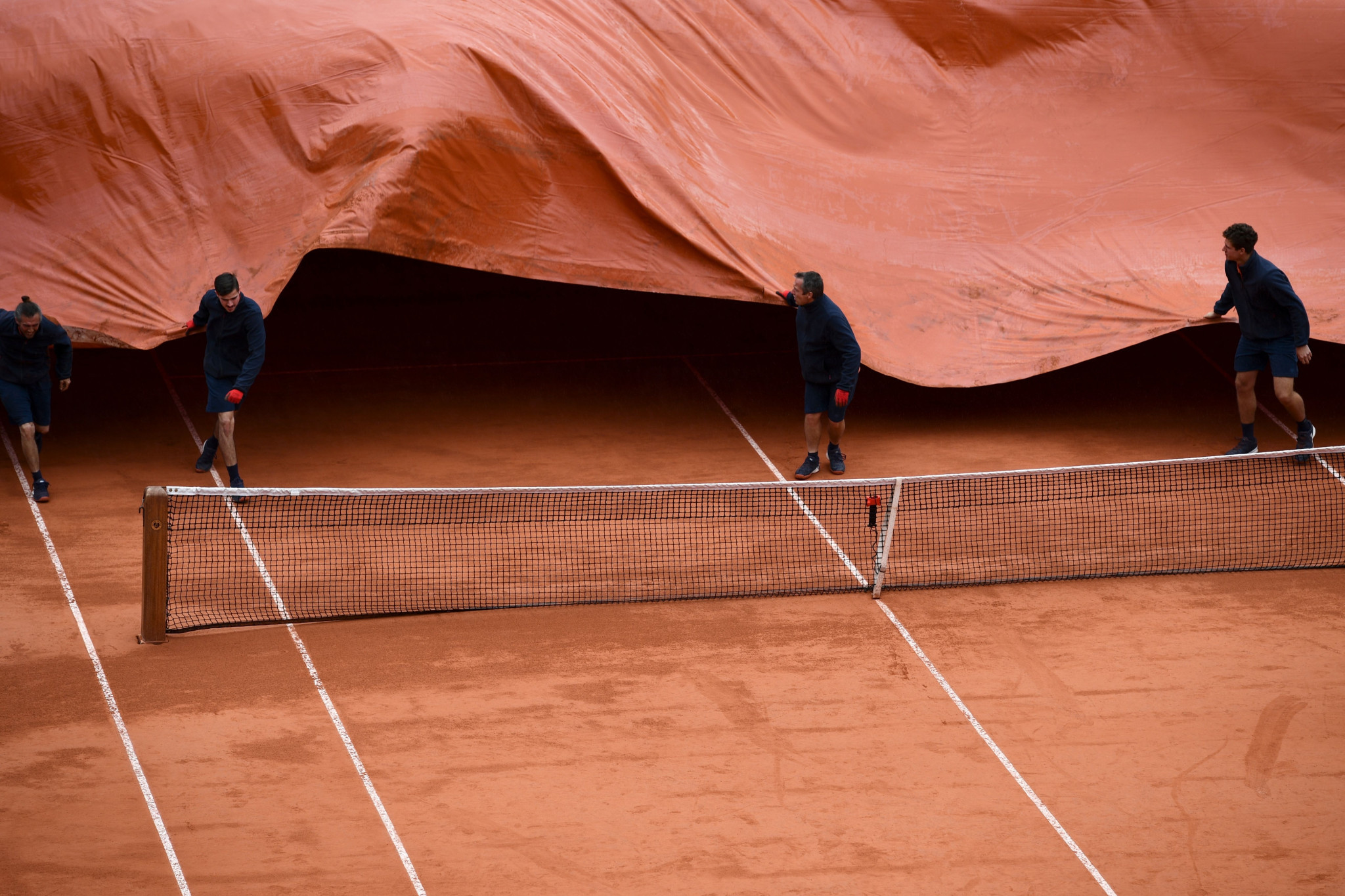The Roland Garros covers were pulled out again on Friday as rain halted Serbian Novak Djokovic and Austrian Dominic Thiem's semi-final ©Getty Images