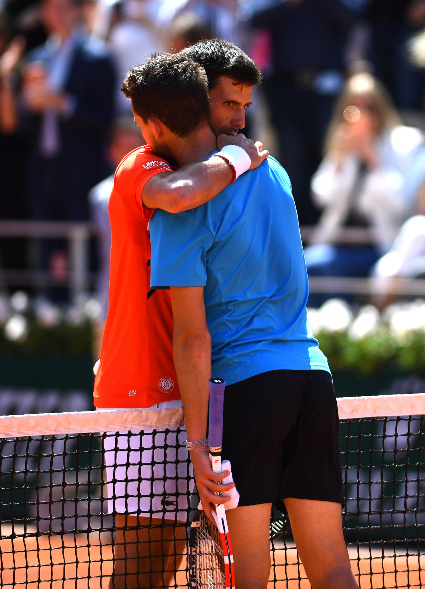 Thiem and Djokovic embrace at the end of their five-set semi-final battle ©Getty Images