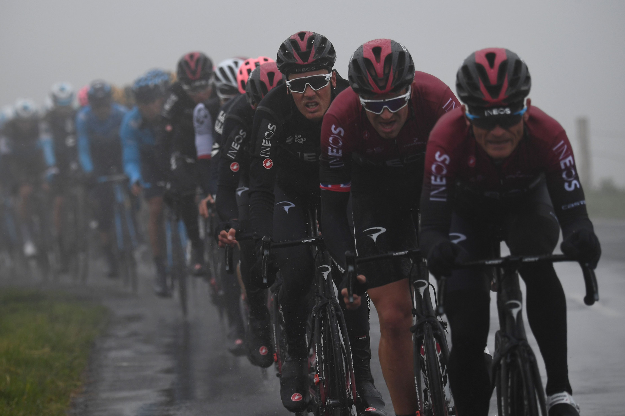 Team Ineos cyclists ride at the front of the peleton in treacherous conditions ©Getty Images