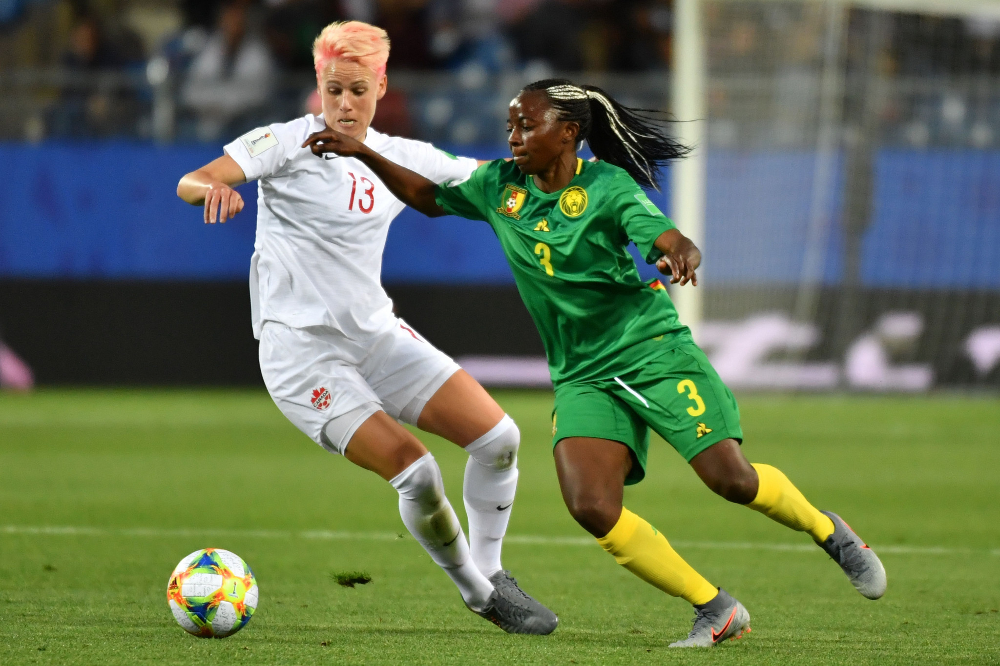 Canada midfielder Sophie Schmidt, left, jostles for possession with Cameroon forward Ajara Nchout ©Getty Images 