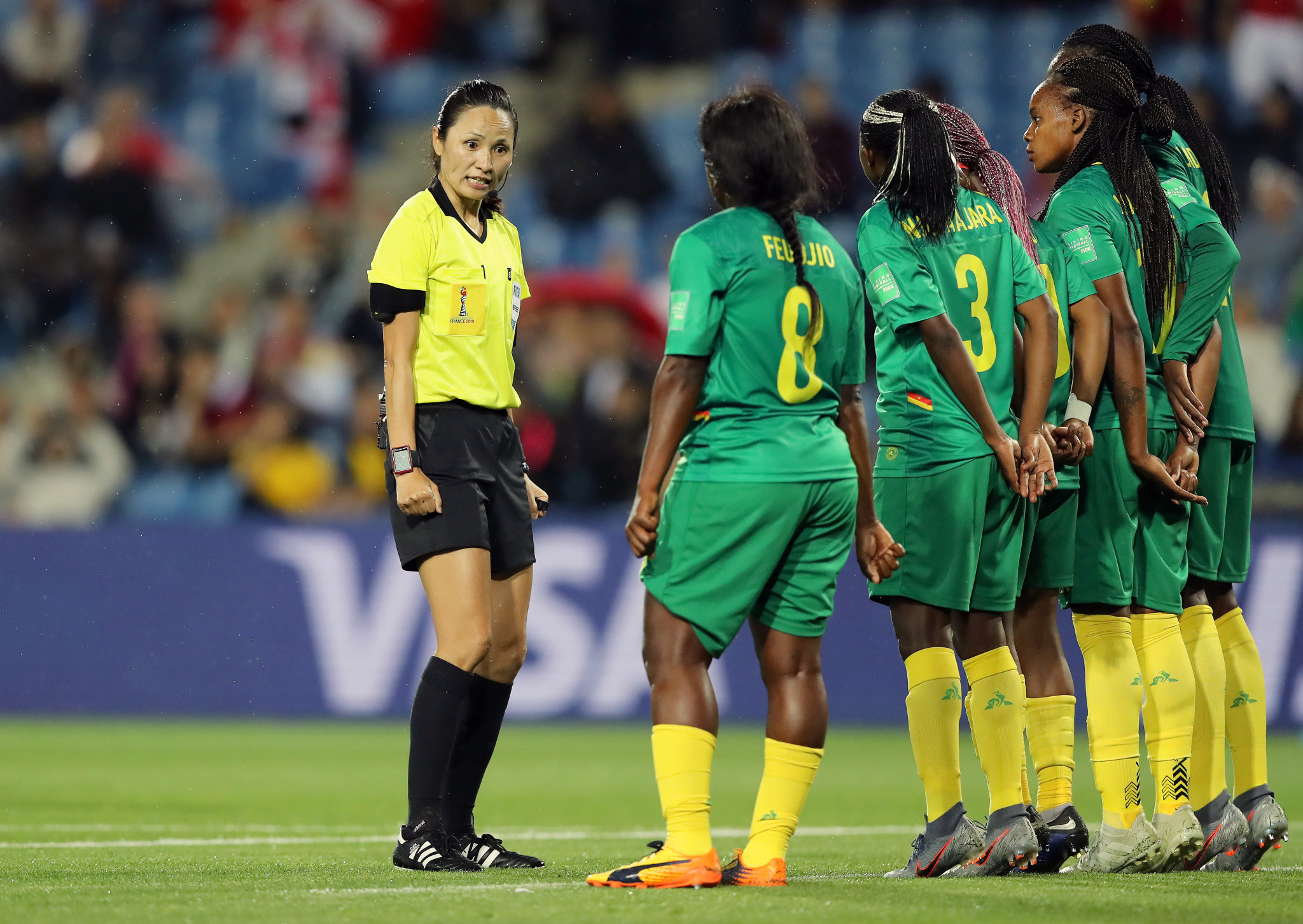 Referee Ri Hyang Ok speaks with the Cameroon defenders as they form a wall against Canada ©Getty Images 