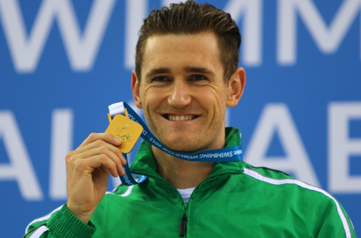 South Africa's Cameron van der Burgh poses with the men's 50m breaststroke gold medal