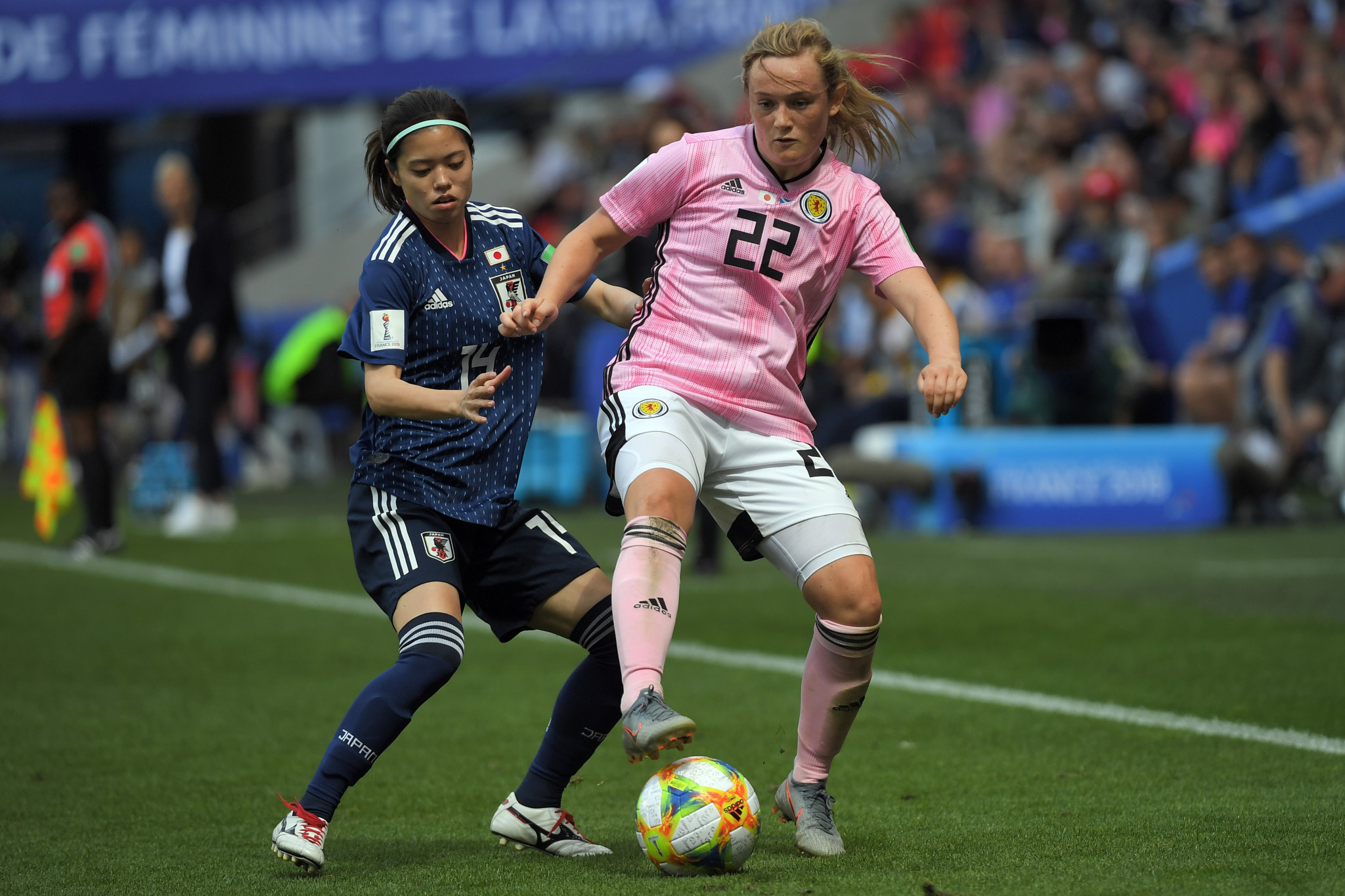Japan midfielder Yui Hasegawa, left, battles for possession with Scottish forward Erin Cuthbert ©Getty Images