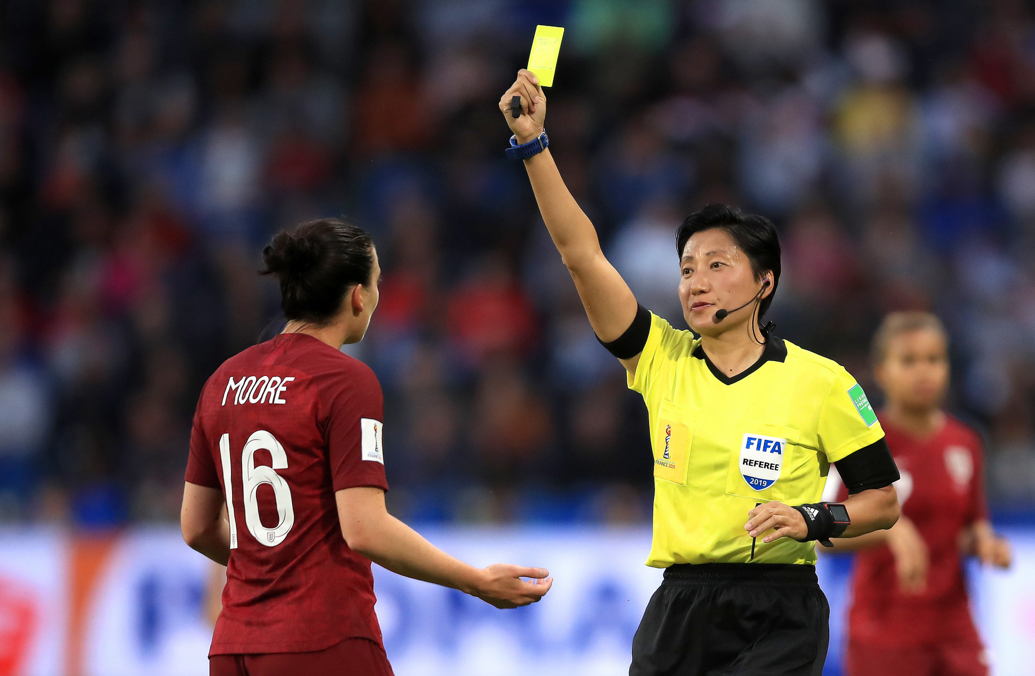 Referee Liang Qin shows Jade Moore of England a yellow card ©Getty Images