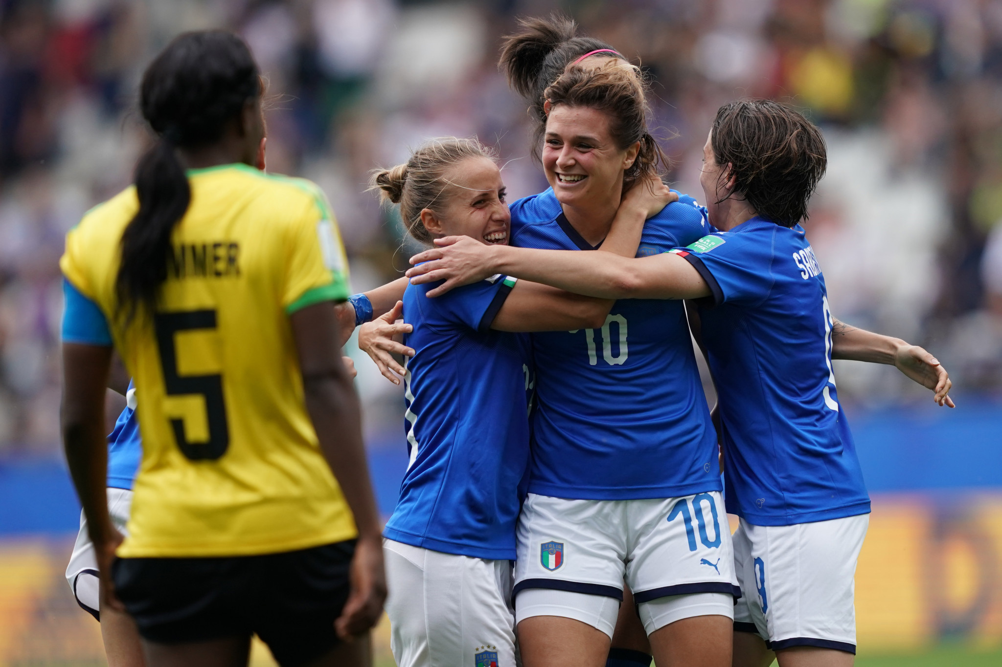 Italy striker Cristiana Girelli, centre, is embraced by her team mates after completing her hat-trick against Jamaica ©Getty Images 