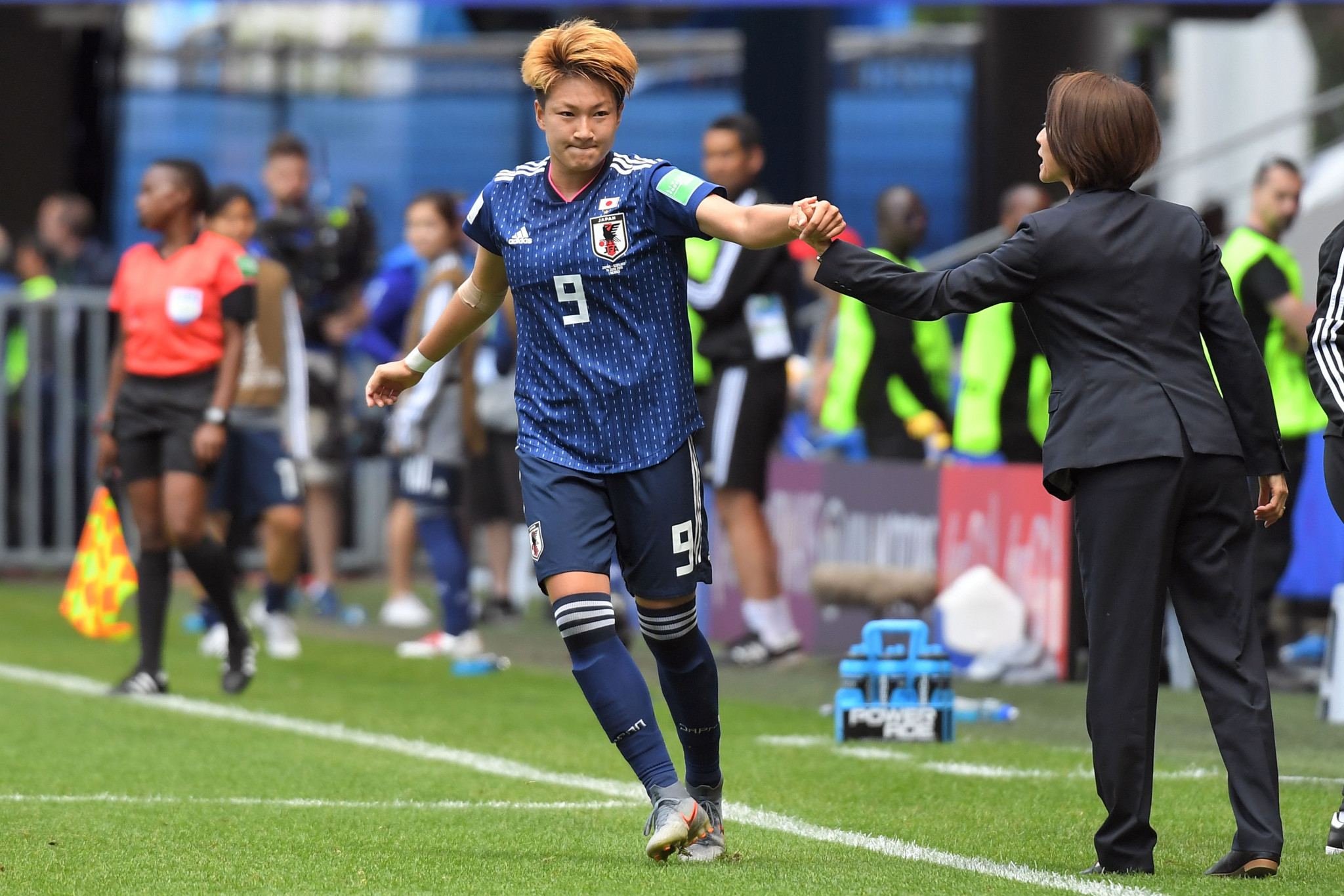 Japan forward Yuika Sugasawa, left, is congratulated by her coach Asako Takakura after doubling Japan's lead against Scotland ©Getty Images