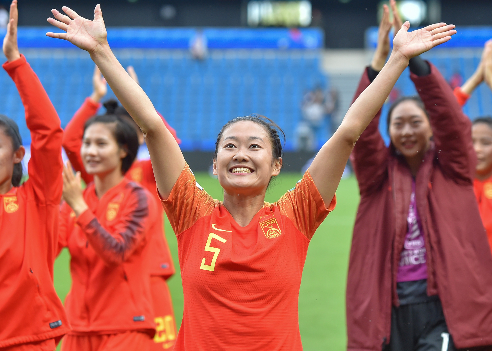 China defender Haiyan Wu, centre, and her team mates celebrate advancing past the group stage following a stalemate with Spain ©Getty Images 