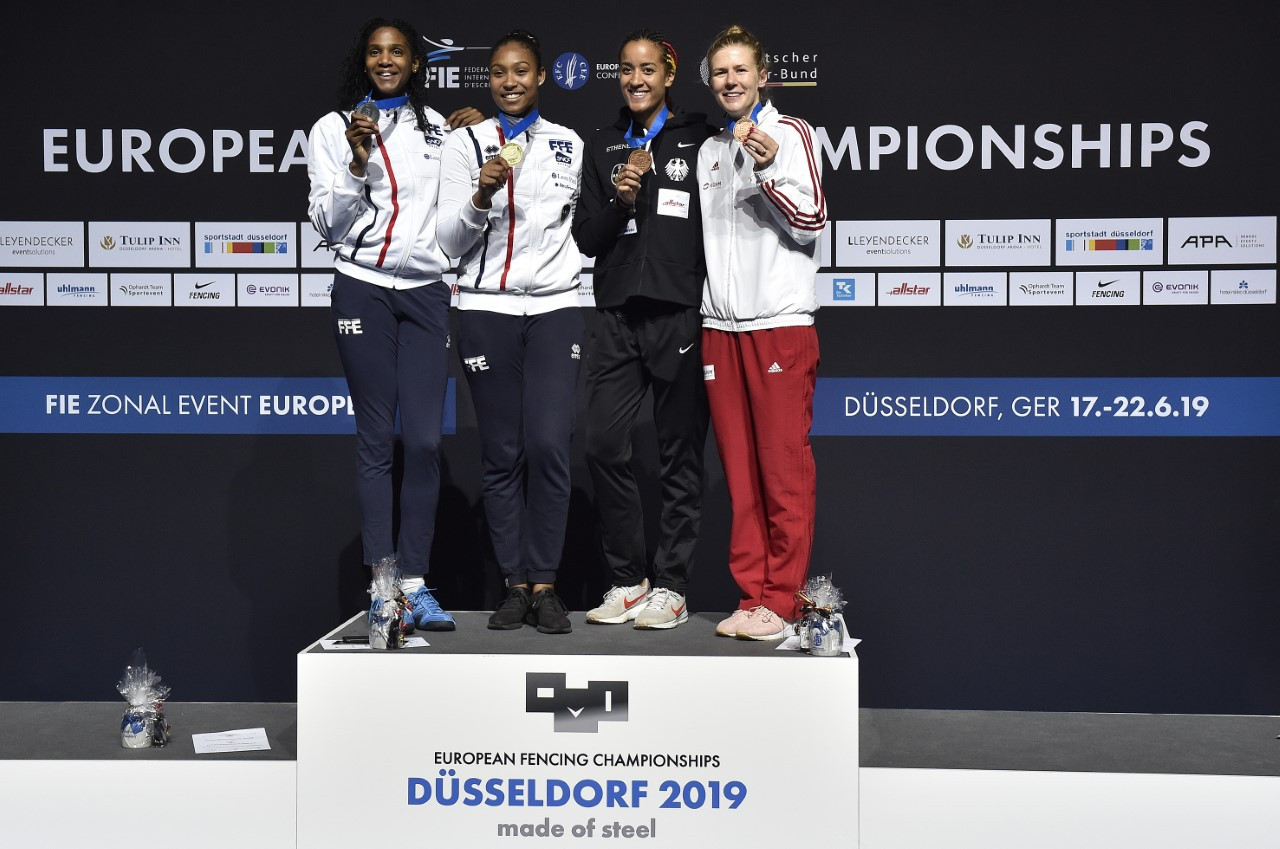 France’s Coraline Vitalis tops the podium after winning the women's épée title at the European Fencing Championships in Düsseldorf, beating team-mate Marie-Florence Candassamy in the final ©European Fencing