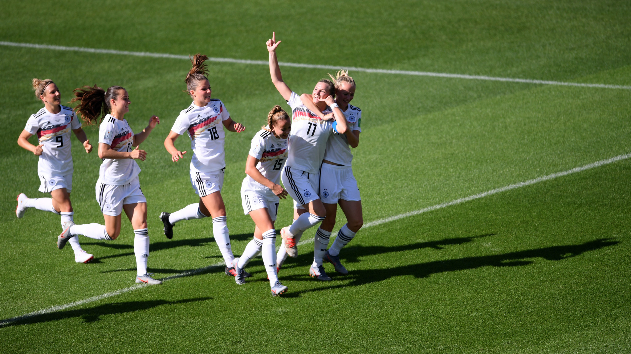 Popp is mobbed by her team mates after her header opened the scoring in Grenoble ©Getty Images
