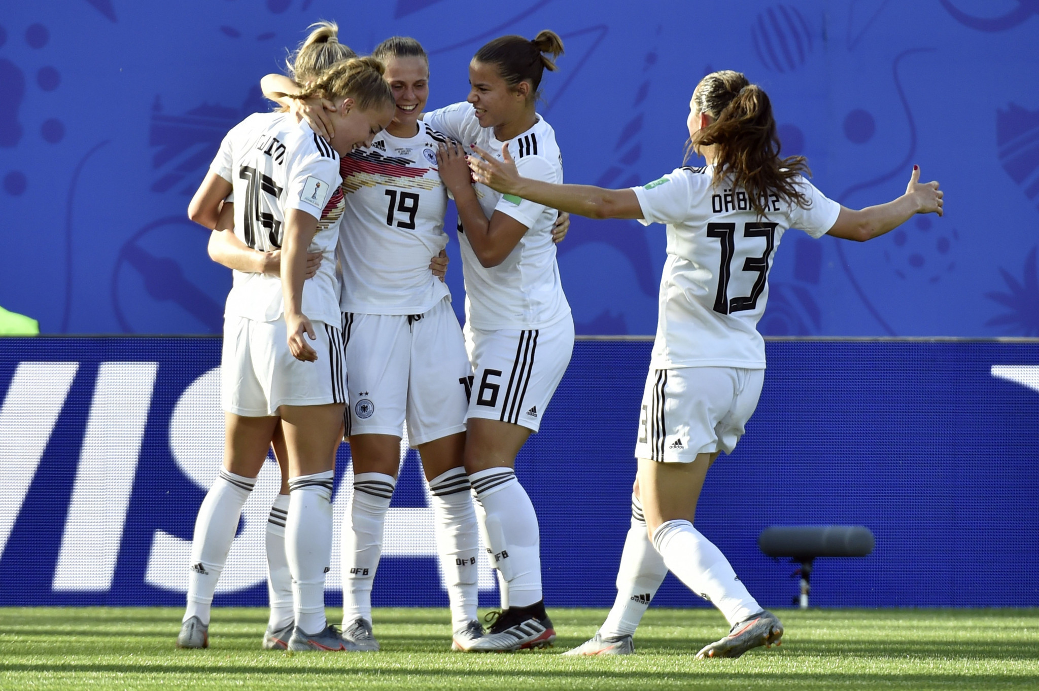 Lea Schuller, hidden, is congratulated by team mates after scoring Germany's third goal ©Getty Images