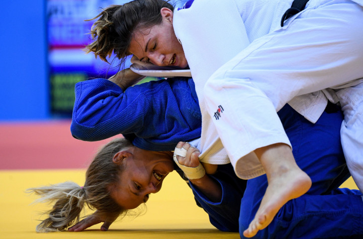 Austria's Michaela Polleres, in white, fights against The Netherlands' Juul Franssen during the second mixed team judo tournament bronze final, which went Austria's way ©Getty Images