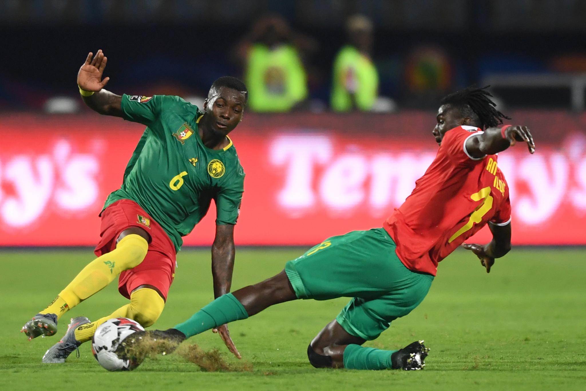 Cameroon defender Ambroise Oyongo, left, vies for the ball with Guinea-Bissau forward Frederic Mendy in the two sides opening match at the Africa Cup of Nations in  Ismailia ©Getty Images