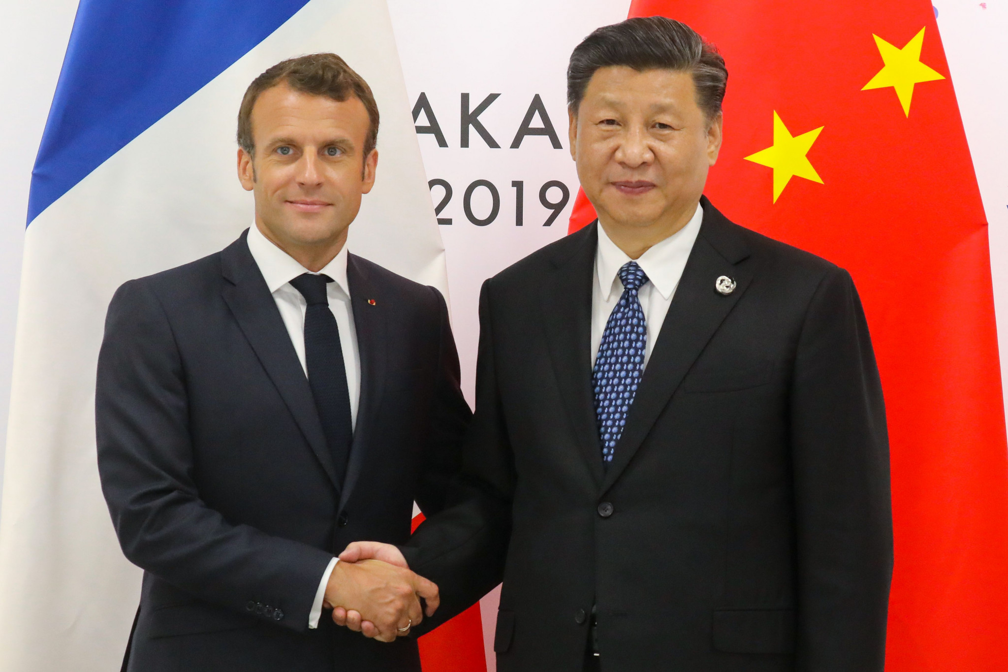 French President Emmanuel Macron, left, and Chinese President Xi Jinping pictured at the G20 Summit in Osaka, were among the world leaders to listen to the speech from IOC President Thomas Bach ©Getty Images