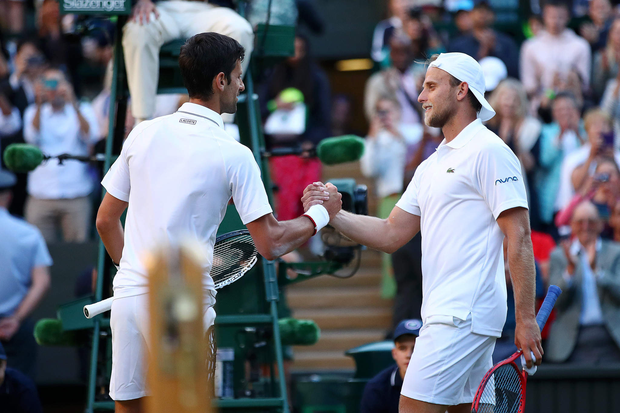 The duo shake hands at the net after Djokovic's straight-sets win ©Getty Images