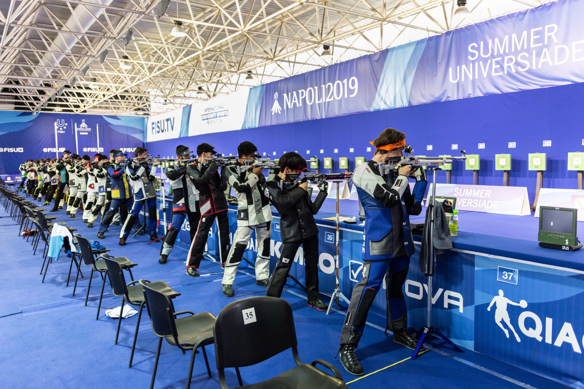 Shooters take aim during the men's 10m air rifle qualification round at Mostra d'Oltremare ©Naples 2019