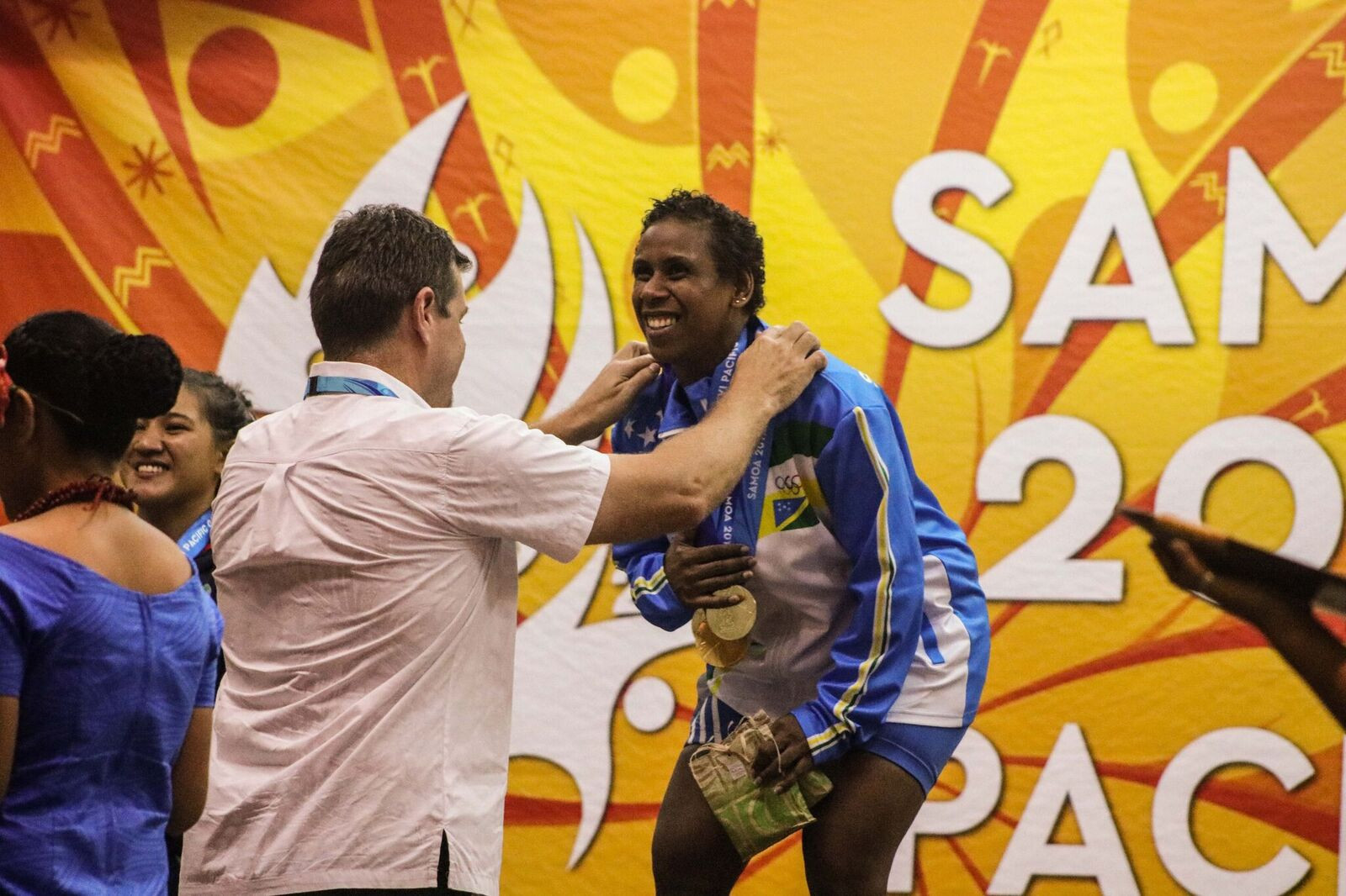 Mary Kini Lifu receives Solomon Islands' first gold medal of the games in weightlifting ©Pacific Games News Service
