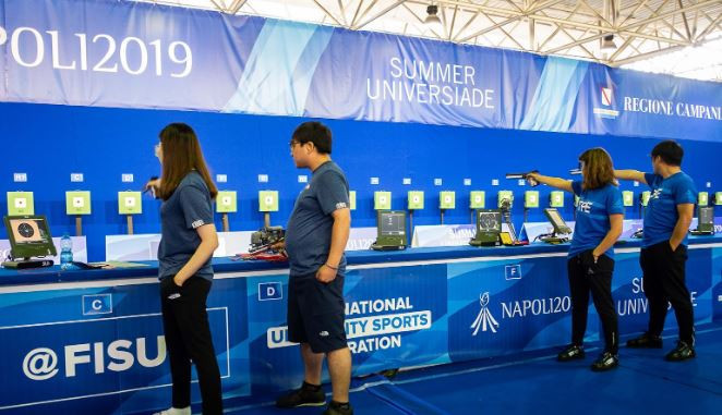 Competitors take aim during the mixed team 10m air pistol final ©Naples 2019