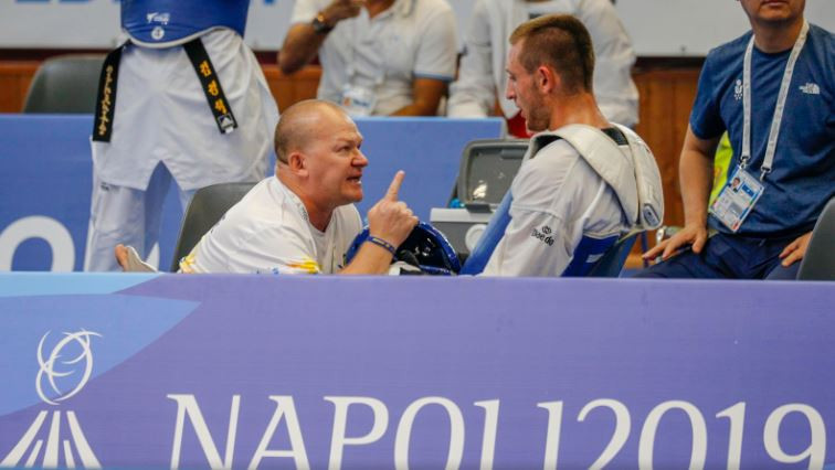 A Universiade athlete gets some advice during a break in proceedings at the taekwondo ©Naples 2019