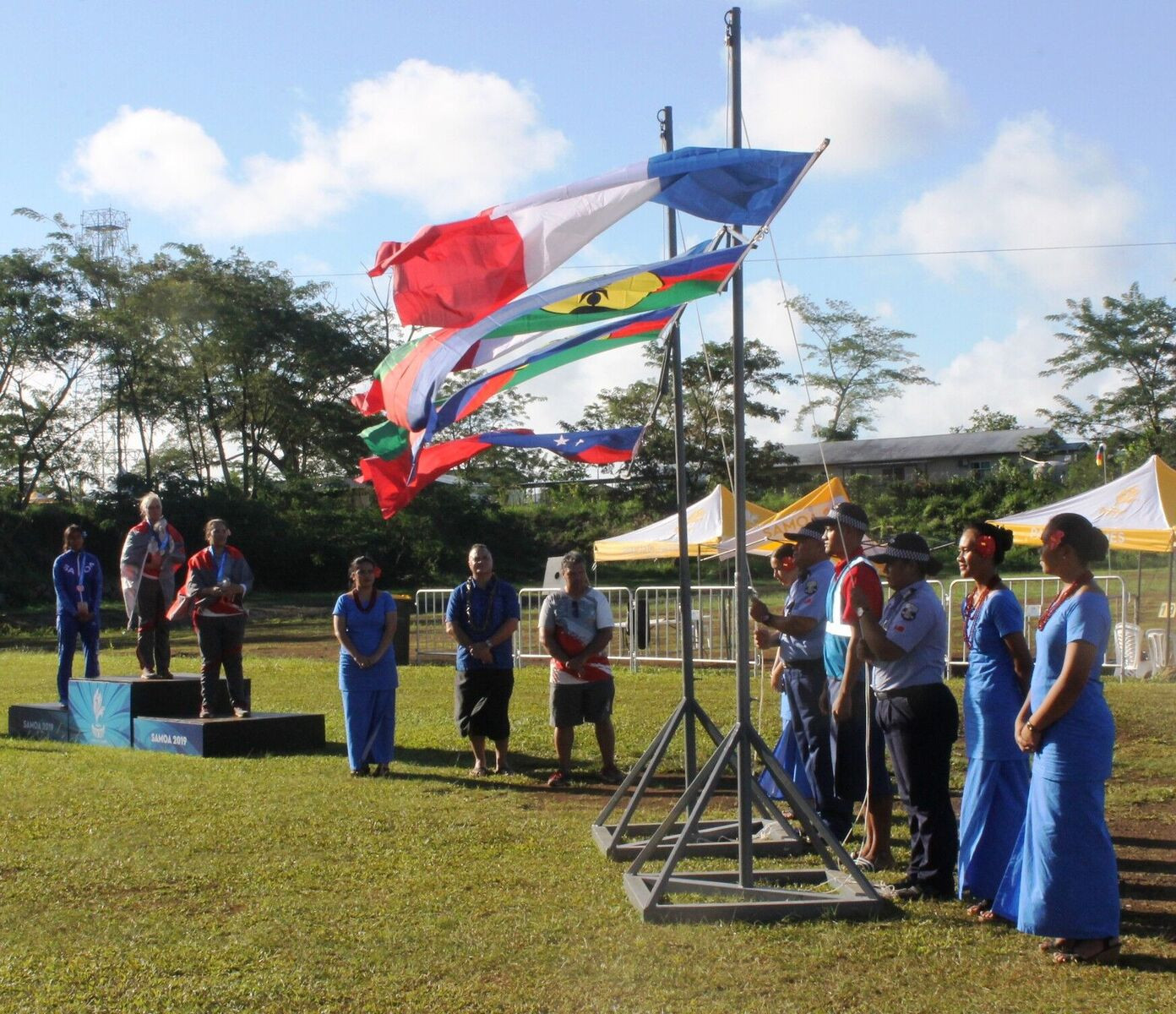 A strong breeze during a medal ceremony at the archery causes the flags to flutter ©Samoa 2019