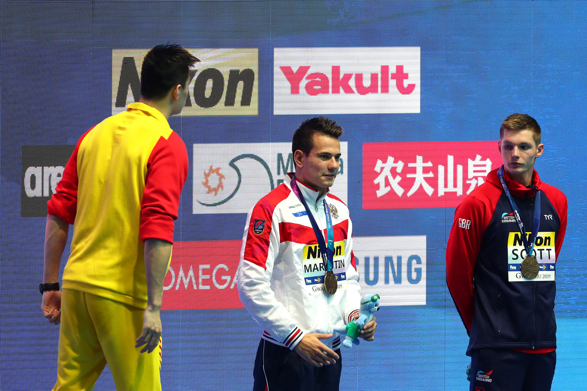 Sun Yang screams at Duncan Scott during the medal ceremony with both swimmers due to receive written warnings from FINA ©Getty Images