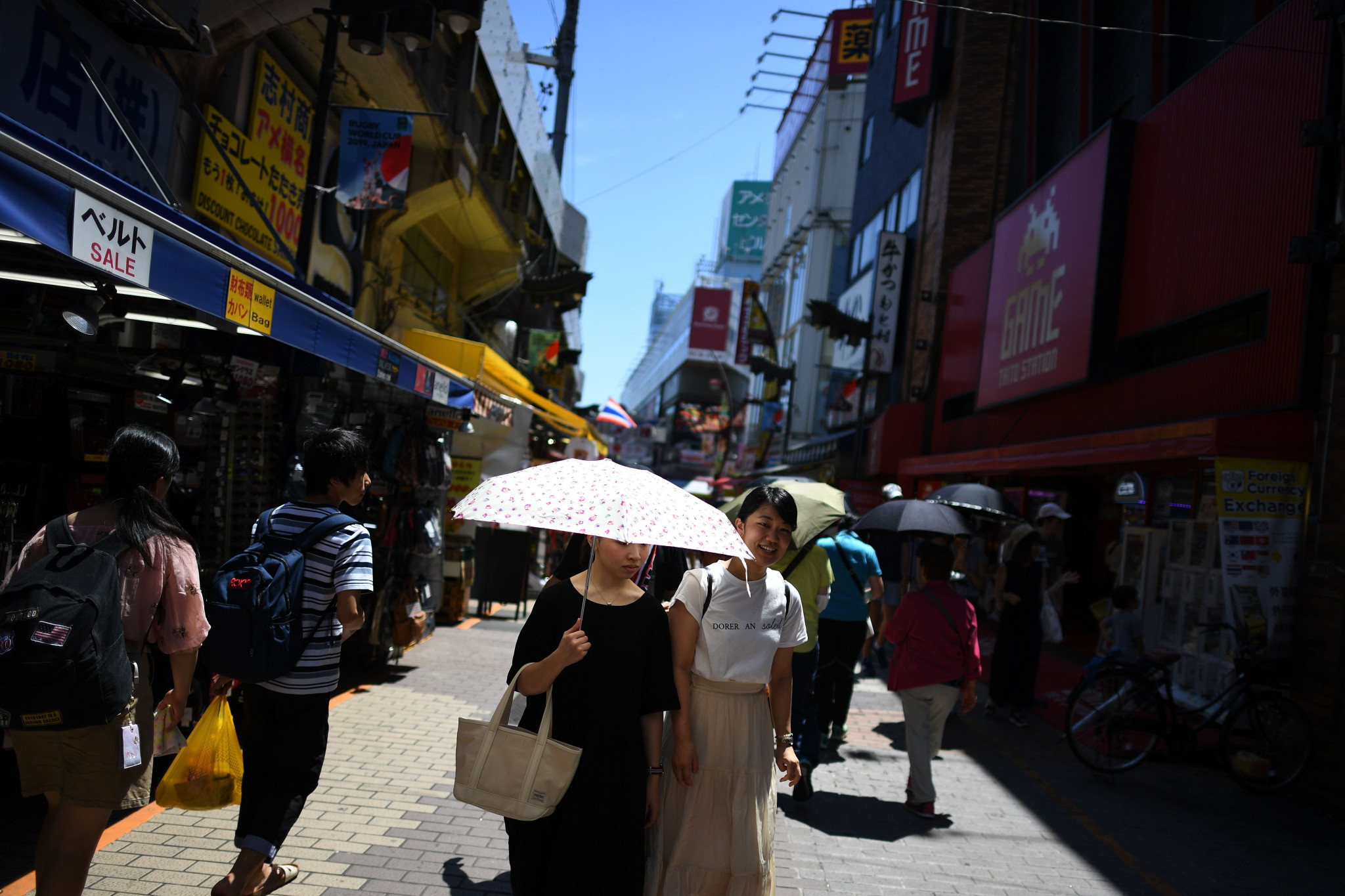 Japanese residents have used umbrellas to help shield themselves from the heat as temperatures soared beyond 30 Celsius, causing tens of deaths and thousands of people to be taken to hospital ©Getty Images