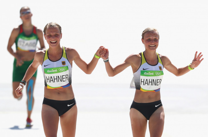 Germany's twins, Lisa and Anna Hahner, hold hands at the finish of the Rio 2016 women's marathon ©Getty Images