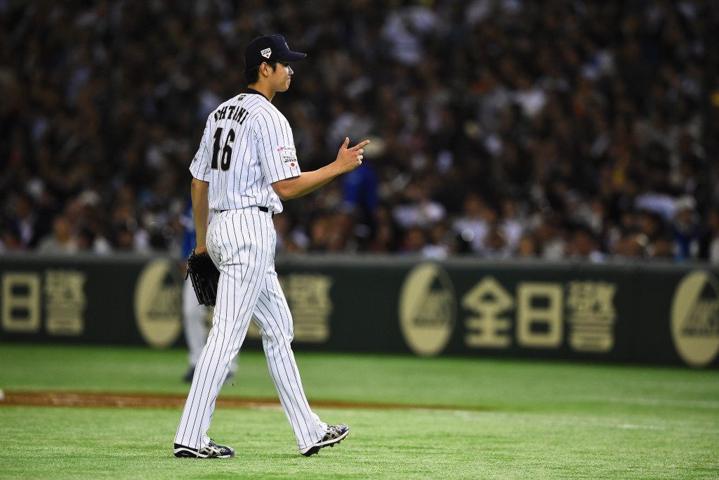 Shohei Ohtani returns to the dugout after pitching seven near perfect innings before South Korea fought back after he was replaced ©Getty Images