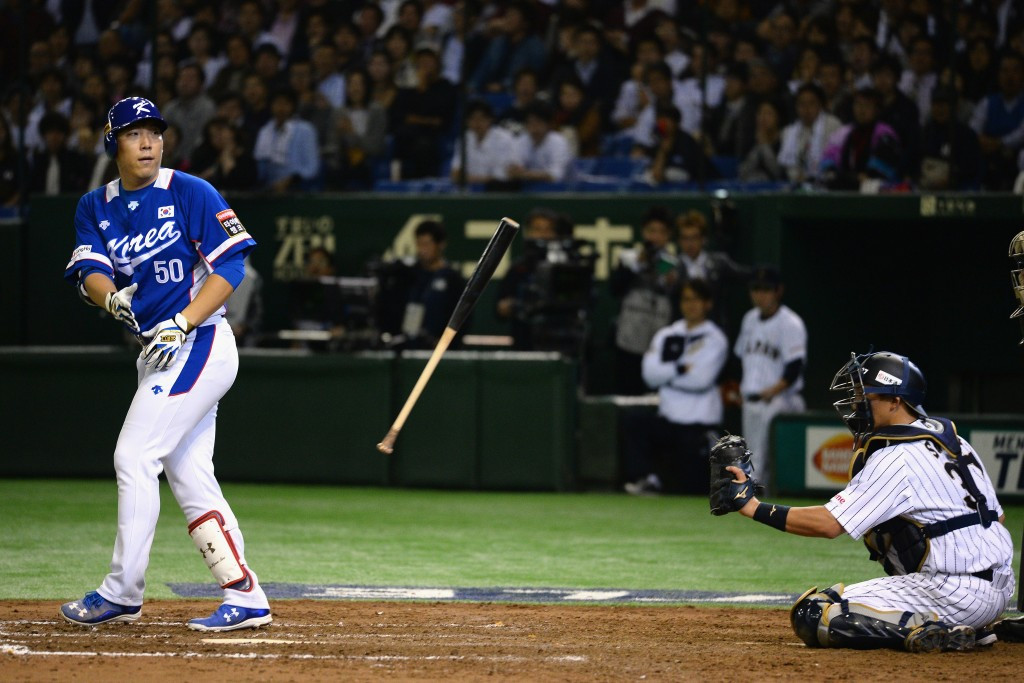 Outfielder Kim Hyunsoo throws his bat after being given a run scoring walk as South Korea recovered to win their semi-final over Japan ©Getty Images