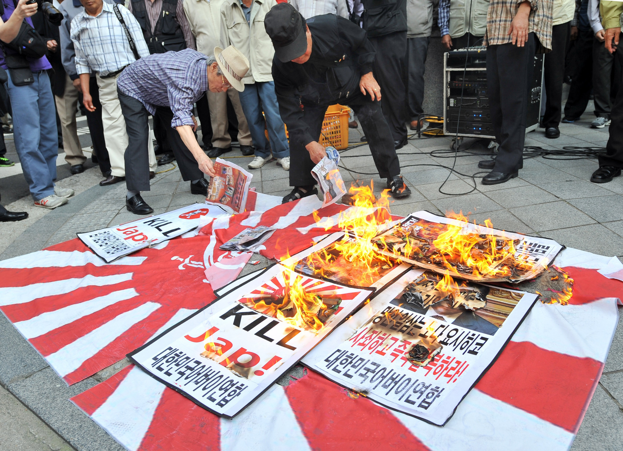 South Korean protestors set fire to a Rising Sun Flag at a rally ©Getty Images