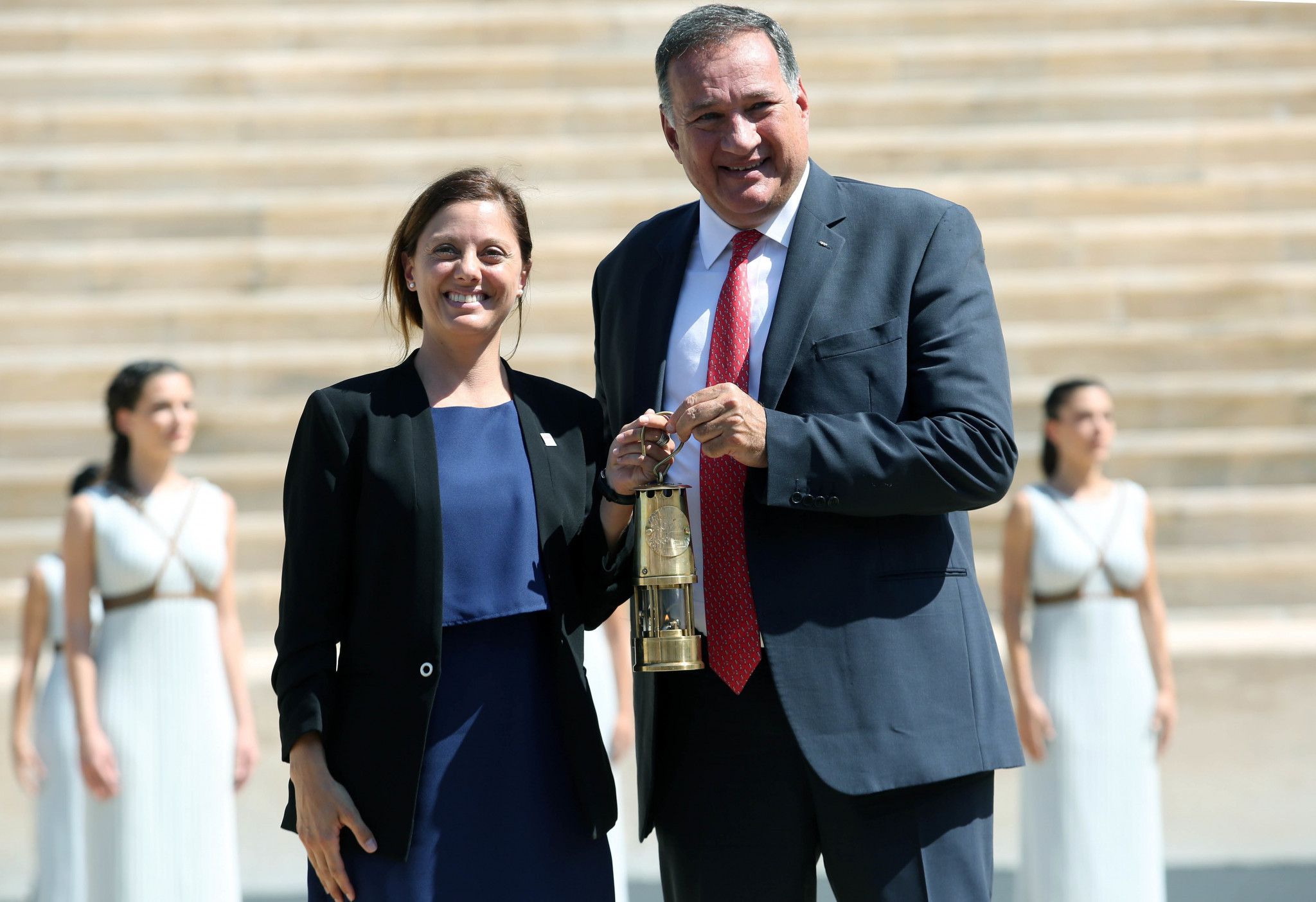 Lausanne 2020 President Virginie Faivre received the flame from Hellenic Olympic Committee President Spyros Capralos ©Hellenic Olympic Committee