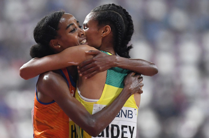 Sifan Hassan of The Netherlands embraces the Ethiopian who chased her home in the women's 10,000m, Letesenbet Gidey, but in the end was outclassed by a runner set to chase a golden Doha double ©Getty Images