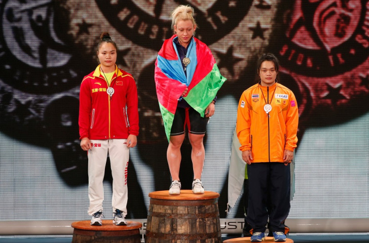 Kostova stands atop the women's 58kg overall podium with Deng and Chinese Taipei's Hsing-Chun Kuo either side of her ©Getty Images