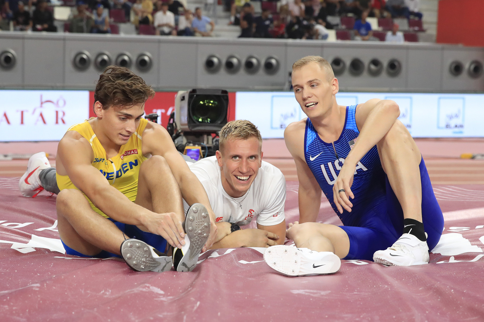 Gold medallist Sam Kendricks of the United States and the silver and bronze medallists Armand Duplantis of Sweden and Piotr Lisek of Poland celebrate after the men's pole vault ©Getty Images