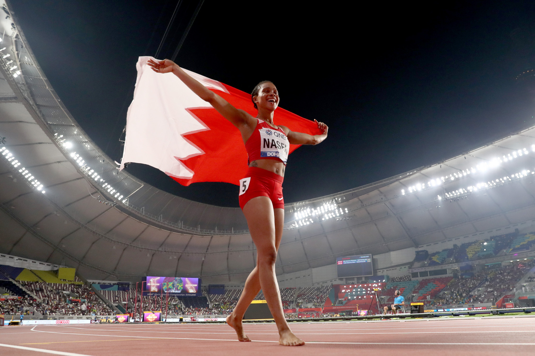 Naser, originally born in Nigeria, waves the flag of her adopted country during her lap of honours ©Getty Images