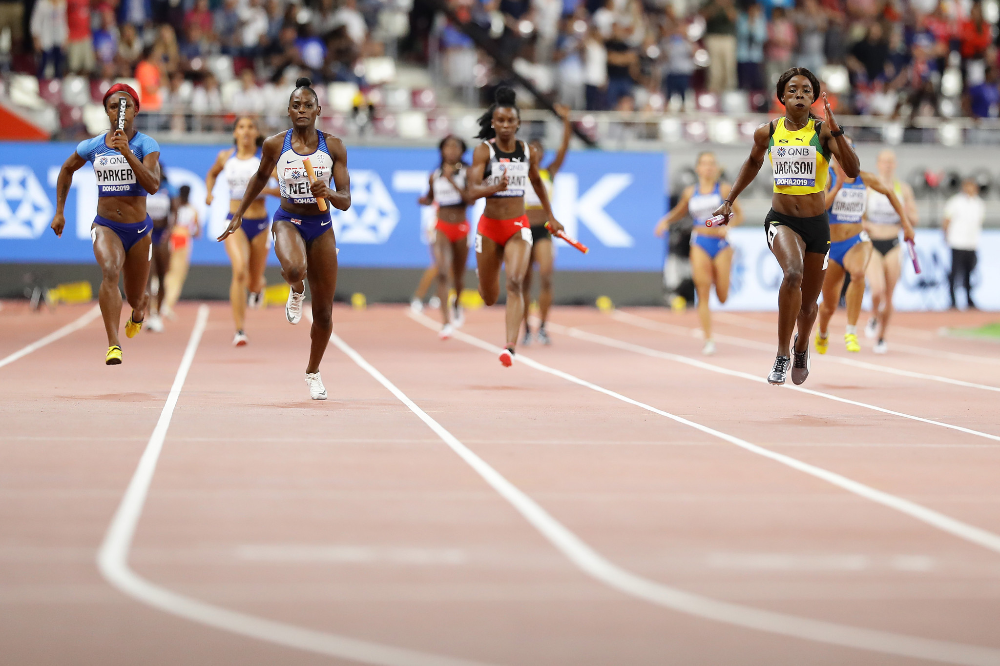 Shericka Jackson of Jamaica, Daryll Neita of Great Britain and Kiara Parker of the US compete in the women's 4x100m relay ©Getty Images