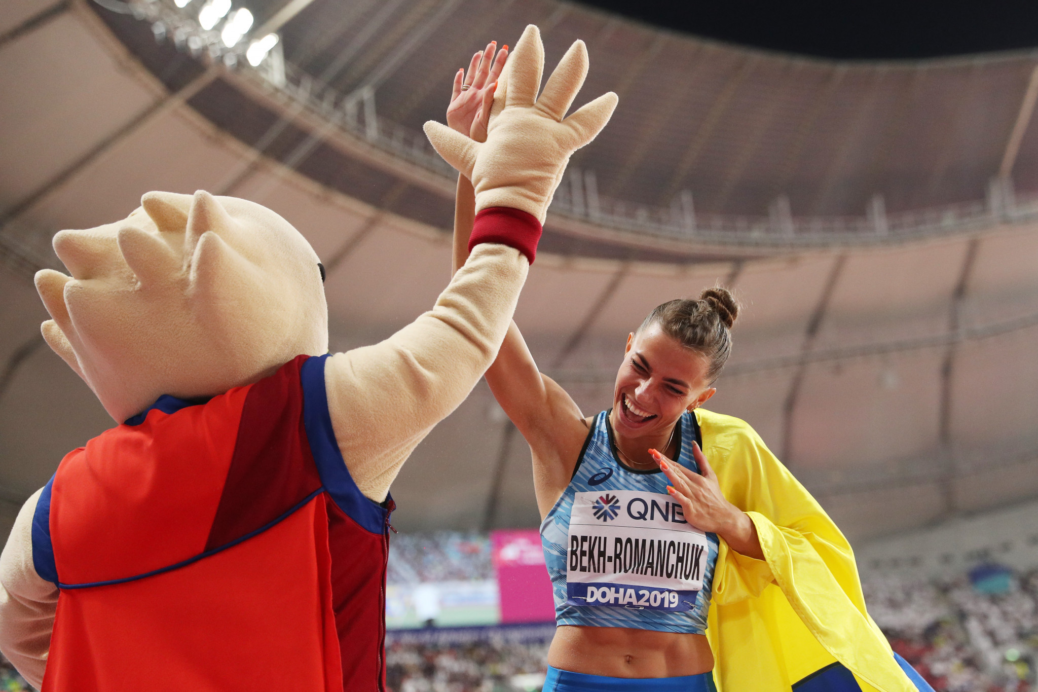 Maryna Bekh-Romanchuk of Ukraine celebrates her silver medal in the women's long jump with a fan 